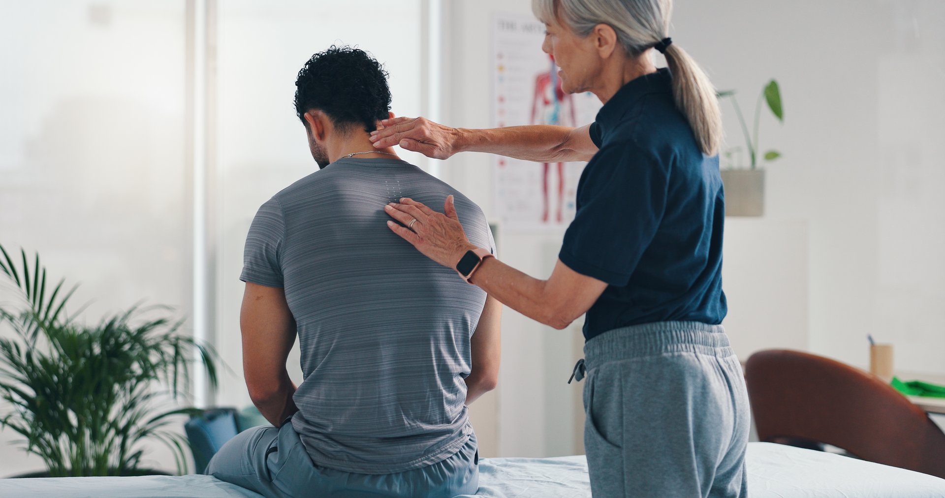 Chiropractor adjusting a patient's neck in a modern clinic