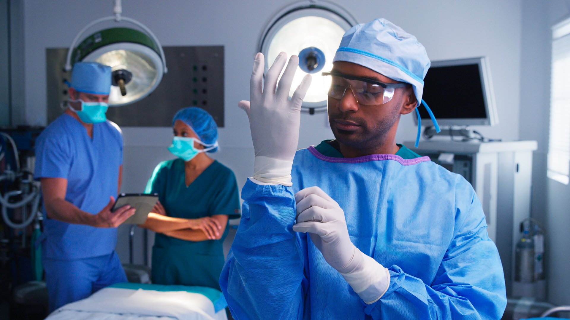 Cosmetic surgeon in scrubs preparing for surgery in operating theater